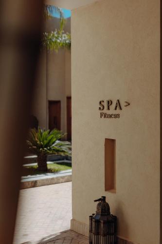 a building with a sign on the side of it at Sirayane Boutique Hotel & Spa Marrakech in Marrakesh