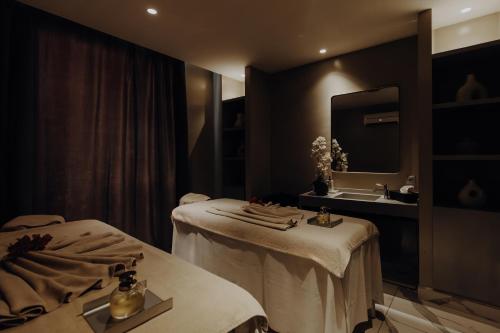a massage room with two beds and a sink at Sirayane Boutique Hotel & Spa Marrakech in Marrakesh