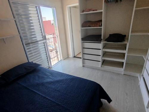 a bedroom with a bed and a closet with shelves at Apartamento completo 2 quartos a 3km basílica in Aparecida
