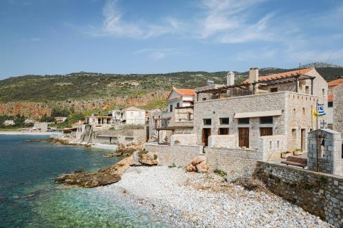 a group of buildings next to the water at Aura Seafront Villa in Neon Oitilon