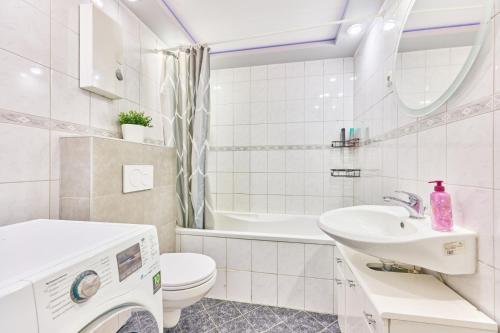 a white bathroom with a sink and a toilet at Ida, the suburban apartment nearby Cologne in Bergheim