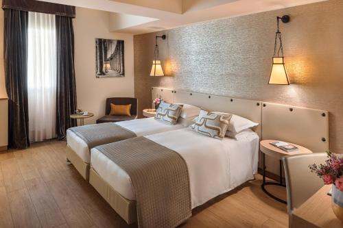 Posteľ alebo postele v izbe v ubytovaní Starhotels Metropole