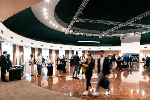 a group of people walking around in a building at Quark Hotel Milano in Milan