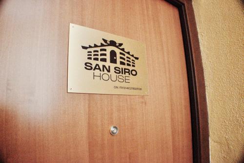 a sign on a door of a house at San Siro House in Milan