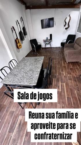 a room with a table and chairs and a couch at Recanto Mãe Aparecida in Aparecida