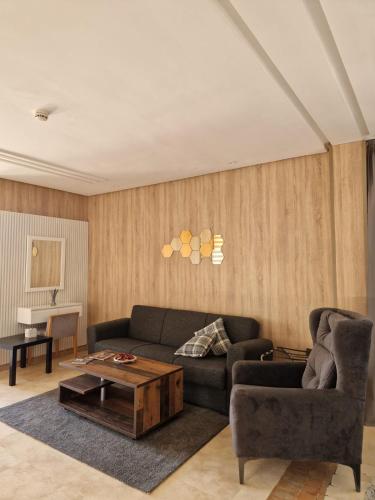 a living room with a couch and a coffee table at Palm Palace Bouznika in Bouznika