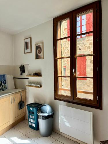 cocina con ventana y cubo de basura en Dove Nest, en Figeac