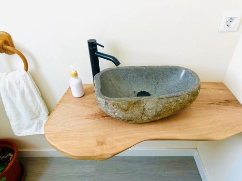 a bathroom with a stone sink on a cutting board at La Moraleja de Sita in Solares