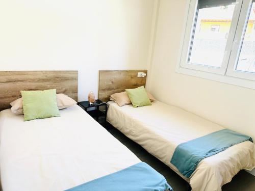 two beds sitting next to each other in a room at La Moraleja de Sita in Solares