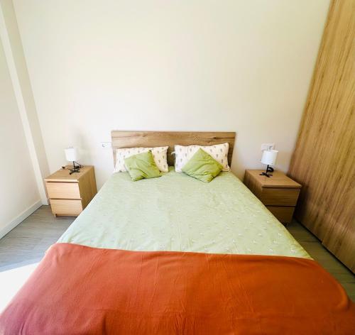 a bedroom with a large bed with two night stands at La Moraleja de Sita in Solares