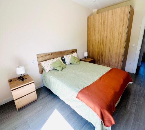 a bedroom with a large bed with a wooden headboard at La Moraleja de Sita in Solares