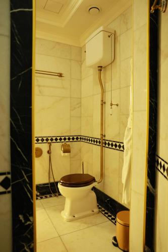 a bathroom with a toilet and a shower at Golden Palace Hotel Yerevan in Yerevan