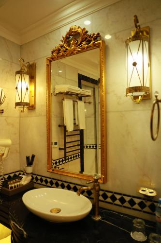 a bathroom with a sink and a mirror at Golden Palace Hotel Yerevan in Yerevan