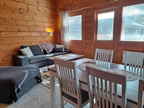 a living room with a table and a couch at Loma-Otso B in Kalajoki