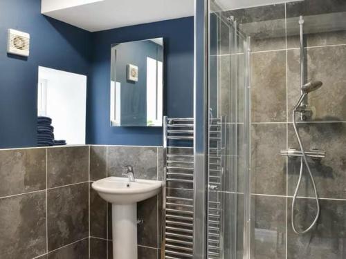 a bathroom with a sink and a shower at Riverview Cottage at Lido Leisure Park in Knaresborough