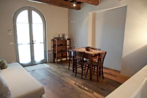 a kitchen with a table, chairs and a refrigerator at Azienda Agricola Baccagnano in Brisighella