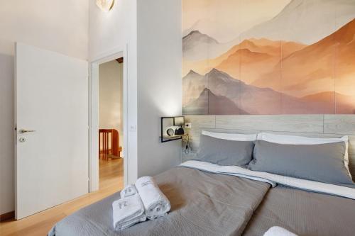 Un dormitorio con una cama con un cuadro en la pared. en Ca'della Melania, en Folgaria