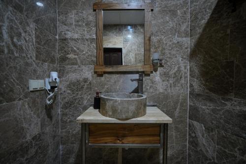 a bathroom with a sink and a mirror at Göreme Cave Lodge in Goreme