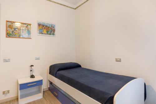 a small bedroom with a bed and a nightstand at Casabb in Toscolano Maderno