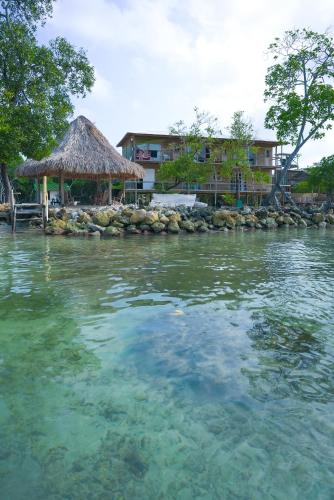 a view of a body of water with a hut at Villa Luz Coastal Sanctuary in Tintipan Island