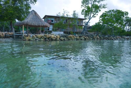 a large body of water with a house in the background at Villa Luz Coastal Sanctuary in Tintipan Island