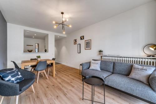 un salon avec un canapé et une table dans l'établissement Appartement avec vue panoramique sur le Lac du Bourget, à Aix-les-Bains