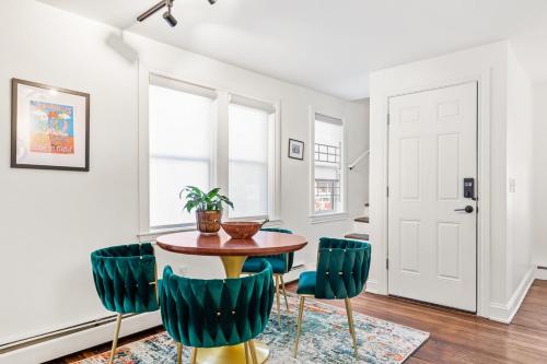 a dining room with a table and green chairs at Federal Hill PRIDE in Providence