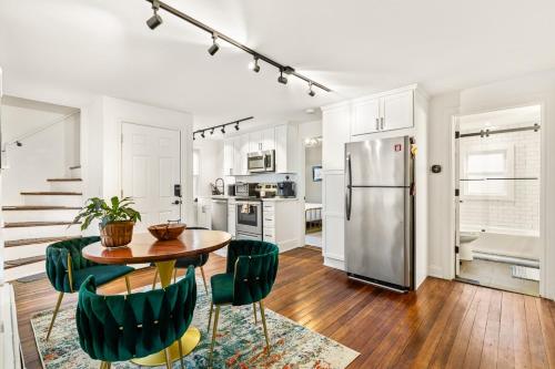 a kitchen with a table and chairs and a refrigerator at Federal Hill PRIDE in Providence
