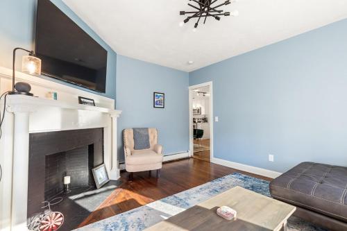 a living room with a couch and a fireplace at Federal Hill PRIDE in Providence
