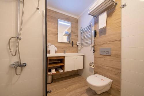 a bathroom with a toilet and a sink and a shower at Çanak Hotel in Canakkale