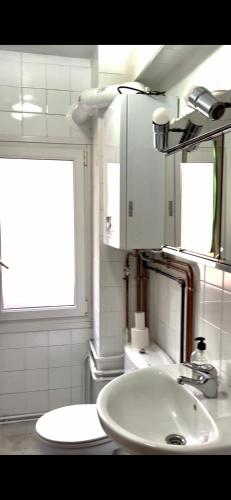 a bathroom with a white sink and a window at Apartament 3 Bedrooms 80m2 Alto Campoo Reinosa Cantabria in Reinosa