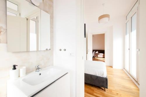 a white bathroom with a sink and a mirror at Casanuova in Rome