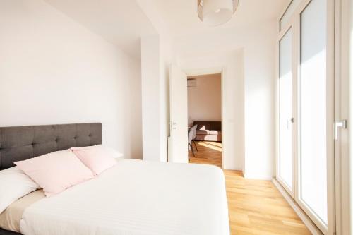a white bedroom with white walls and a large bed at Casanuova in Rome