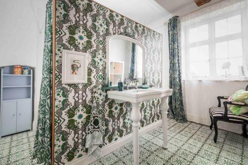 a bathroom with a sink and a mirror at To The Manor Born, cinema, pool table, hot tub in Poole