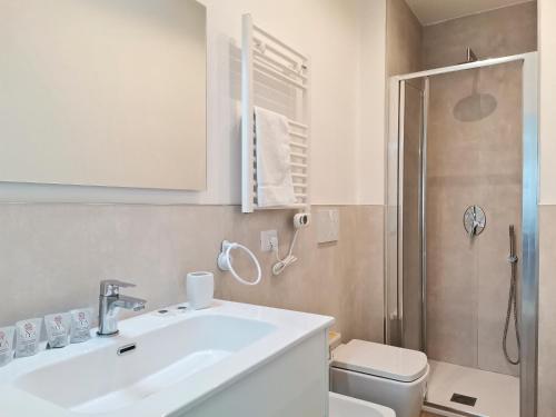 a bathroom with a sink and a toilet and a shower at VerdeMare Big House in Torre a Mare