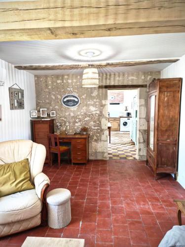 a living room with a couch and a table at Gîte Chez Renée in Azay-le-Ferron