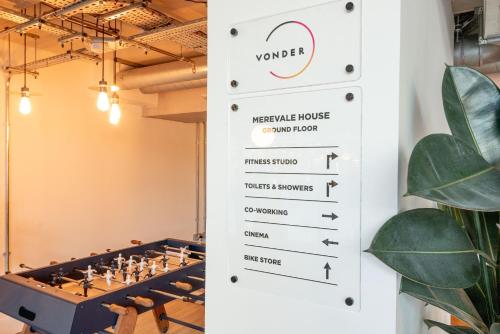 a sign in a room with a chess board at Wembley Stadium Apartments by Sleepy Lodge London in London
