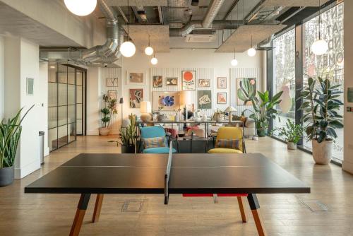 a ping pong table in the middle of a room at Wembley Stadium Apartments by Sleepy Lodge London in London