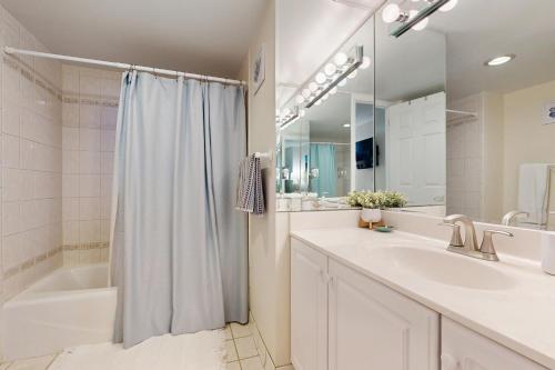 a bathroom with a shower and a tub and a sink at Sea Colony - 1505N Edgewater House in Bethany Beach