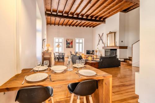 a dining room and living room with a table and chairs at Vila Marisa in Ax-les-Thermes