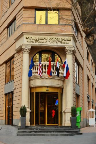 a building with flags on the front of it at Golden Palace Hotel Yerevan in Yerevan