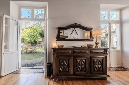 a room with a wooden dresser and a mirror at Vila Marisa in Ax-les-Thermes