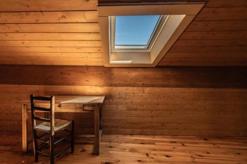 a wooden room with a table and a window at Vila Marisa in Ax-les-Thermes