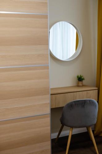 a door with a round mirror and a chair at Little Bucharest downtown apartments Romana in Bucharest