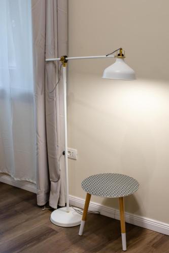 a lamp and a table in a room at Little Bucharest downtown apartments Romana in Bucharest