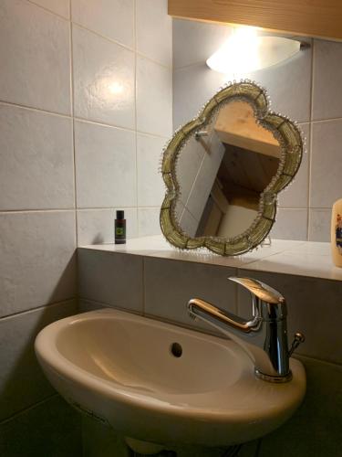 a sink in a bathroom with a mirror on the wall at Luxury Maisonette with Pool in Pallíni