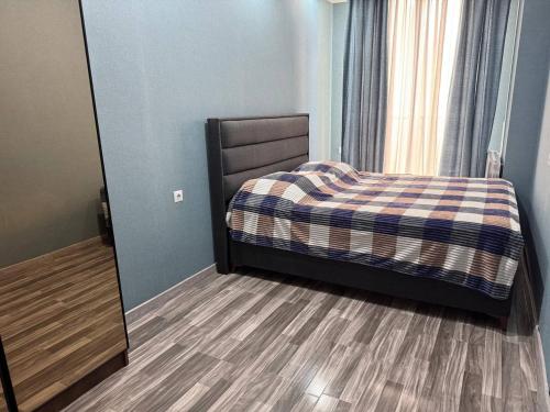 a bedroom with a bed and a mirror at Crystal Apartments in Tbilisi City
