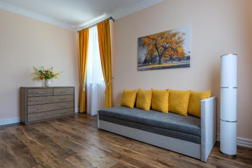 a living room with a couch and a dresser at Penzion Pod Krásnou horou in Benešov nad Černou