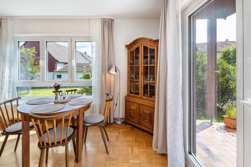 a dining room with a table and chairs and a window at Grashüpfer bis 4 Pers in Freiensteinau