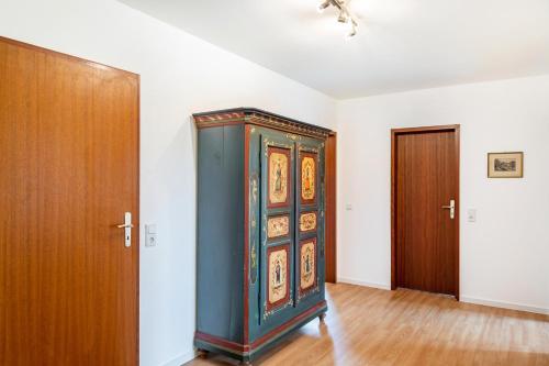 a blue cabinet in a room with two wooden doors at Wildbiene bis 4 Pers in Freiensteinau